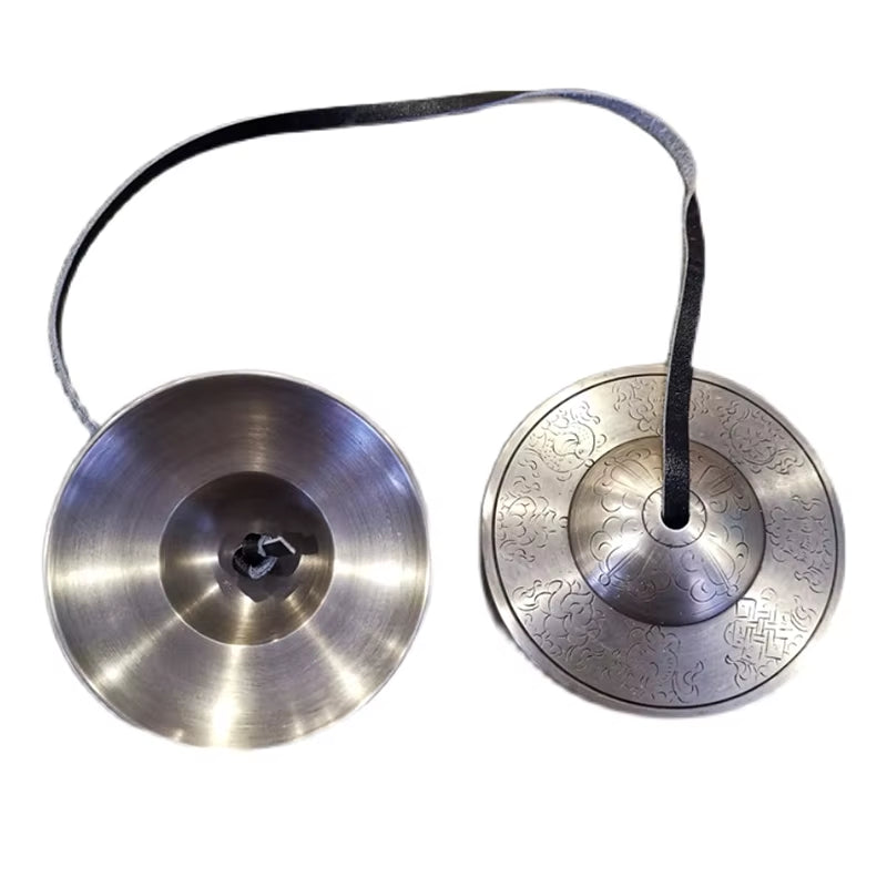 Brass Buddha Hand Cymbals connected by black cord for meditation practice