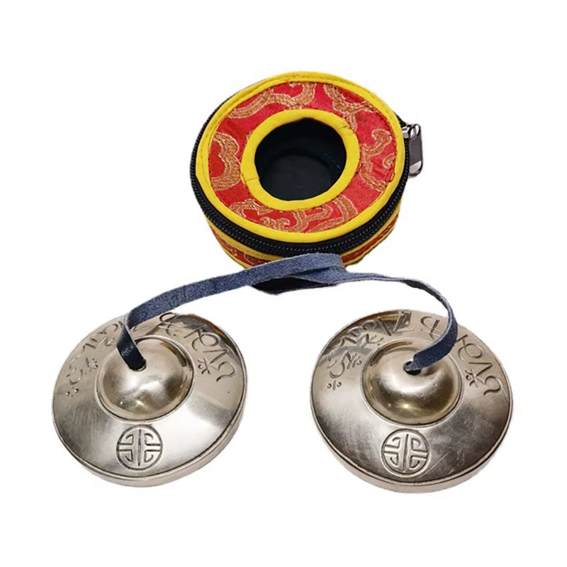 Tibetan meditation tingsha cymbals in red and yellow carrying case for yoga mindfulness