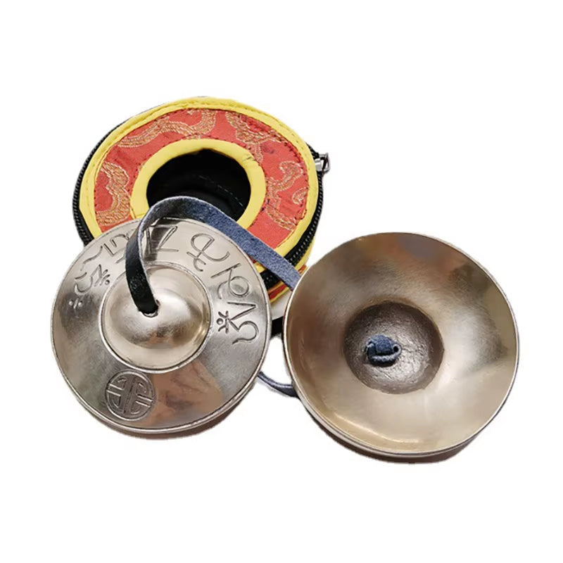 Tibetan meditation tingsha cymbals with red and gold detailing for yoga meditation