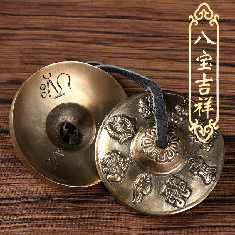 Brass Tingsha Buddha Hand Cymbals with ornate Buddhist symbols for meditation