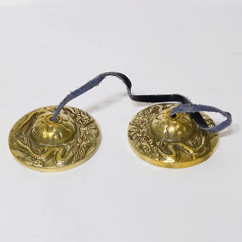 Ornate brass Tibetan meditation tingsha cymbals with blue cord for tranquility