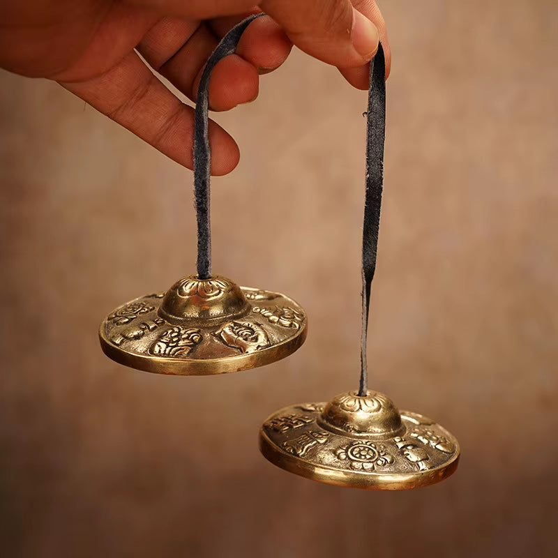 Brass Tingsha Buddha Hand Cymbals with black ribbons for meditation and mindfulness