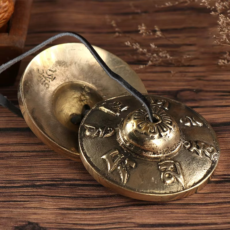 Brass Tingsha Buddha Hand Cymbals with ornate designs for traditional Tibetan meditation