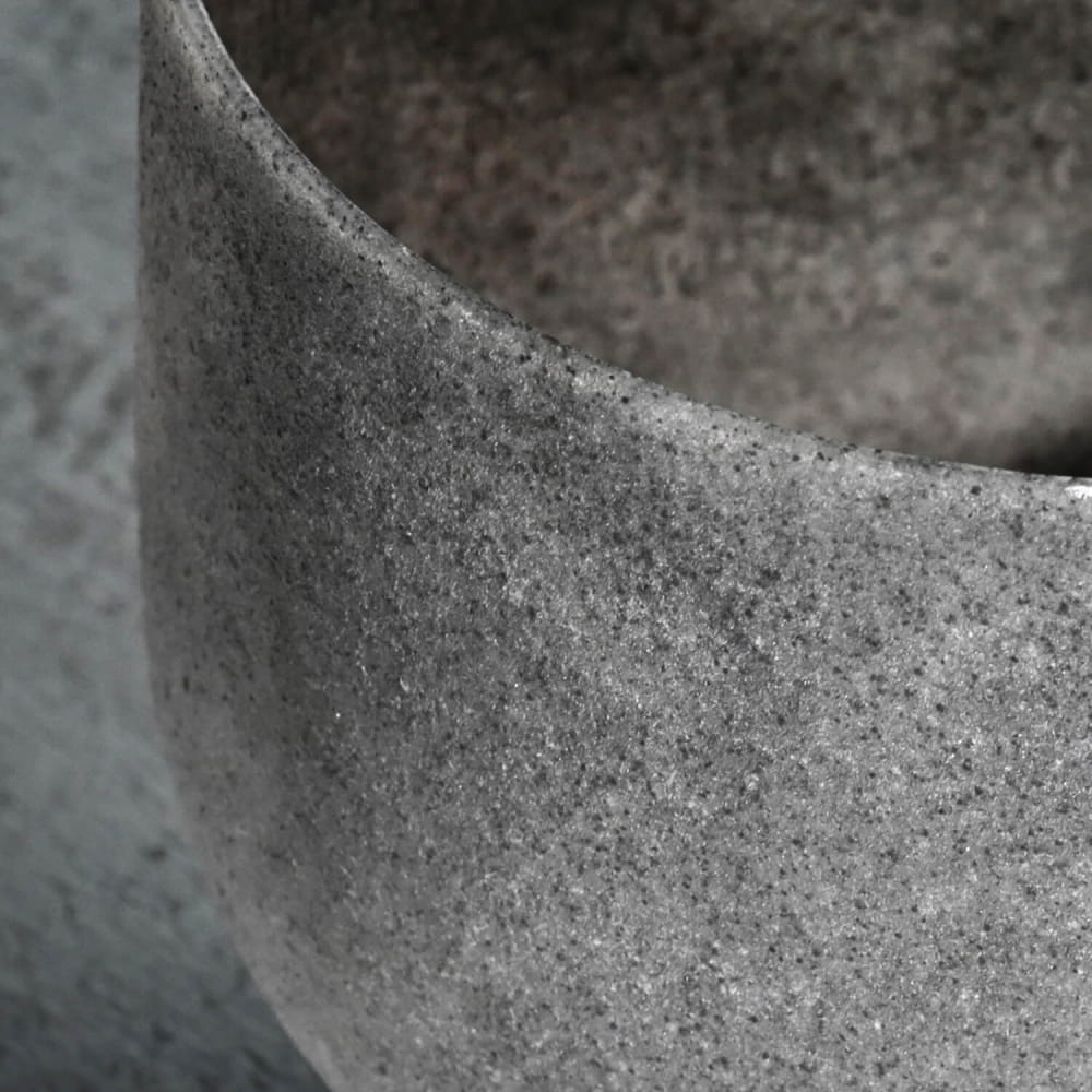 Textured concrete vessel with curved rim of C Note Obsidian Gemstone Fusion Bowl