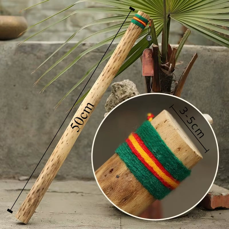 Wooden stick wrapped in green, yellow, and red yarn for Cactus Rainstick Instrument