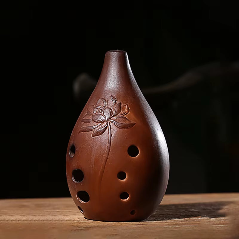 Brown ceramic ocarina with lotus flower design and 10 finger holes for music