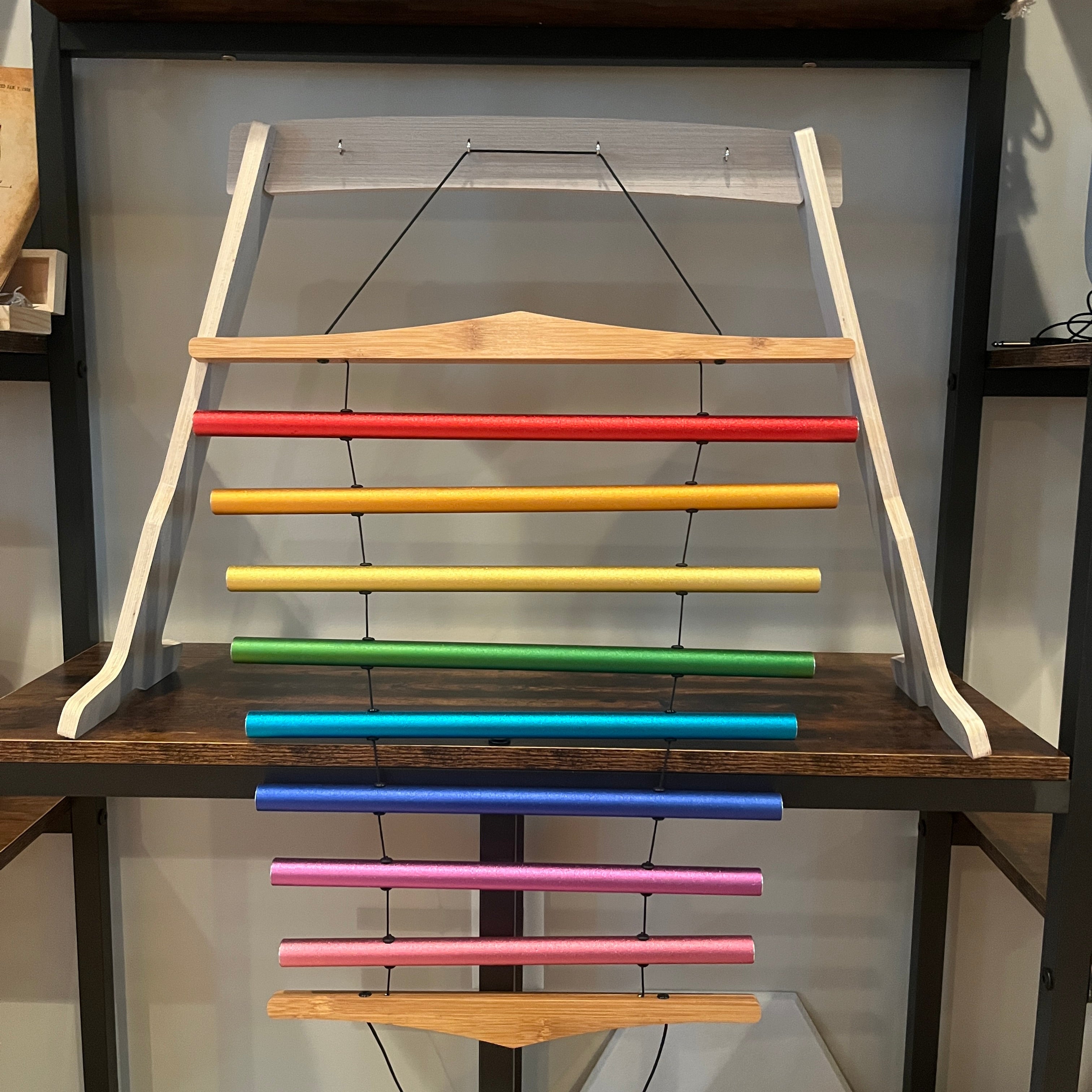 Wooden rack with rainbow-colored bars for Chakra Schumann Swinging Chimes 8-Note