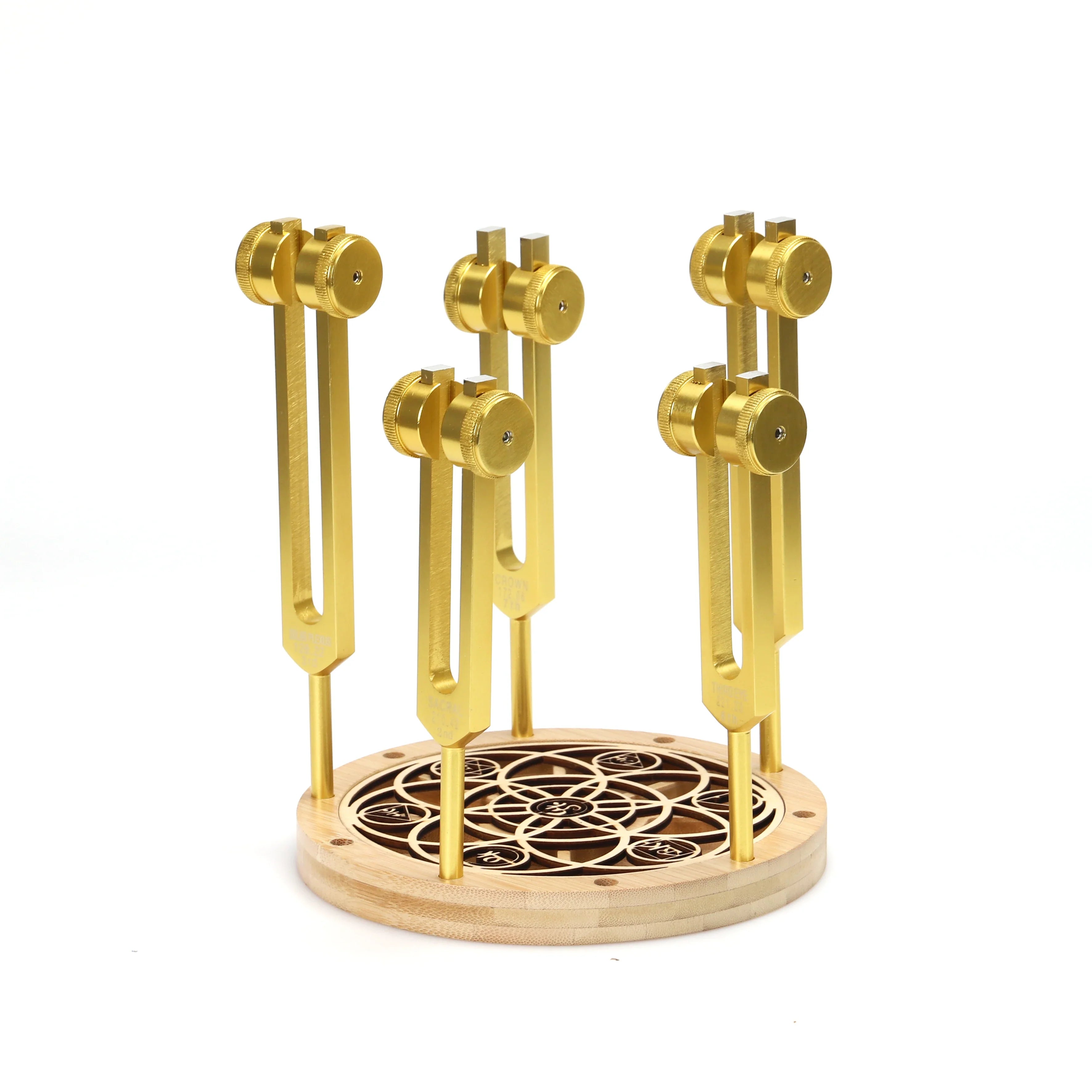 Golden tuning forks on a decorative wooden Chakra Tuning Fork Holder Stand - Capacity 10