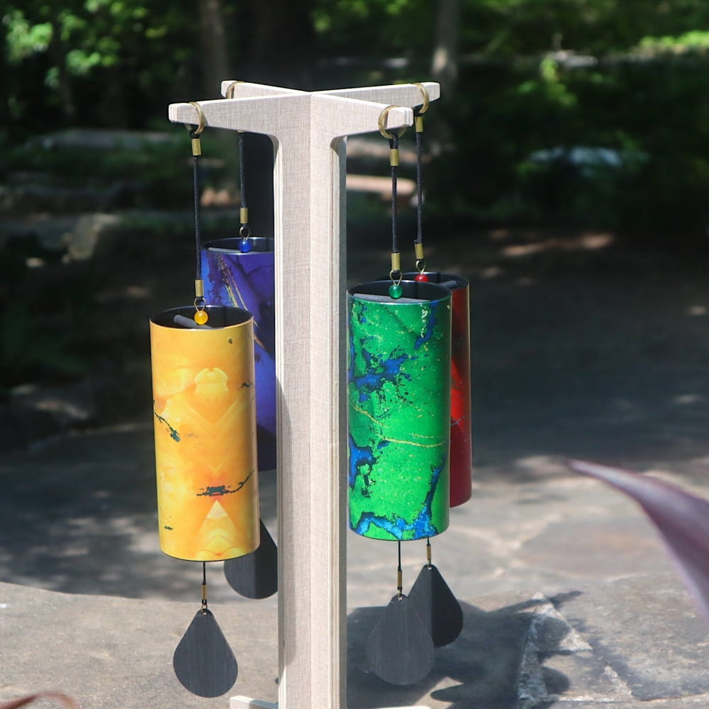 Colorful wind chimes from Colored Koshi Chimes Set of 4 Elements hanging on a stand