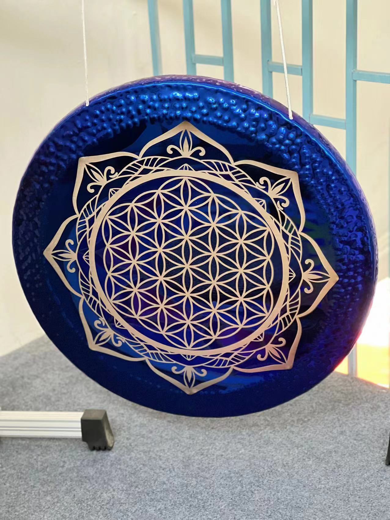 Circular blue drum with silver Flower of Life mandala design for sound healing