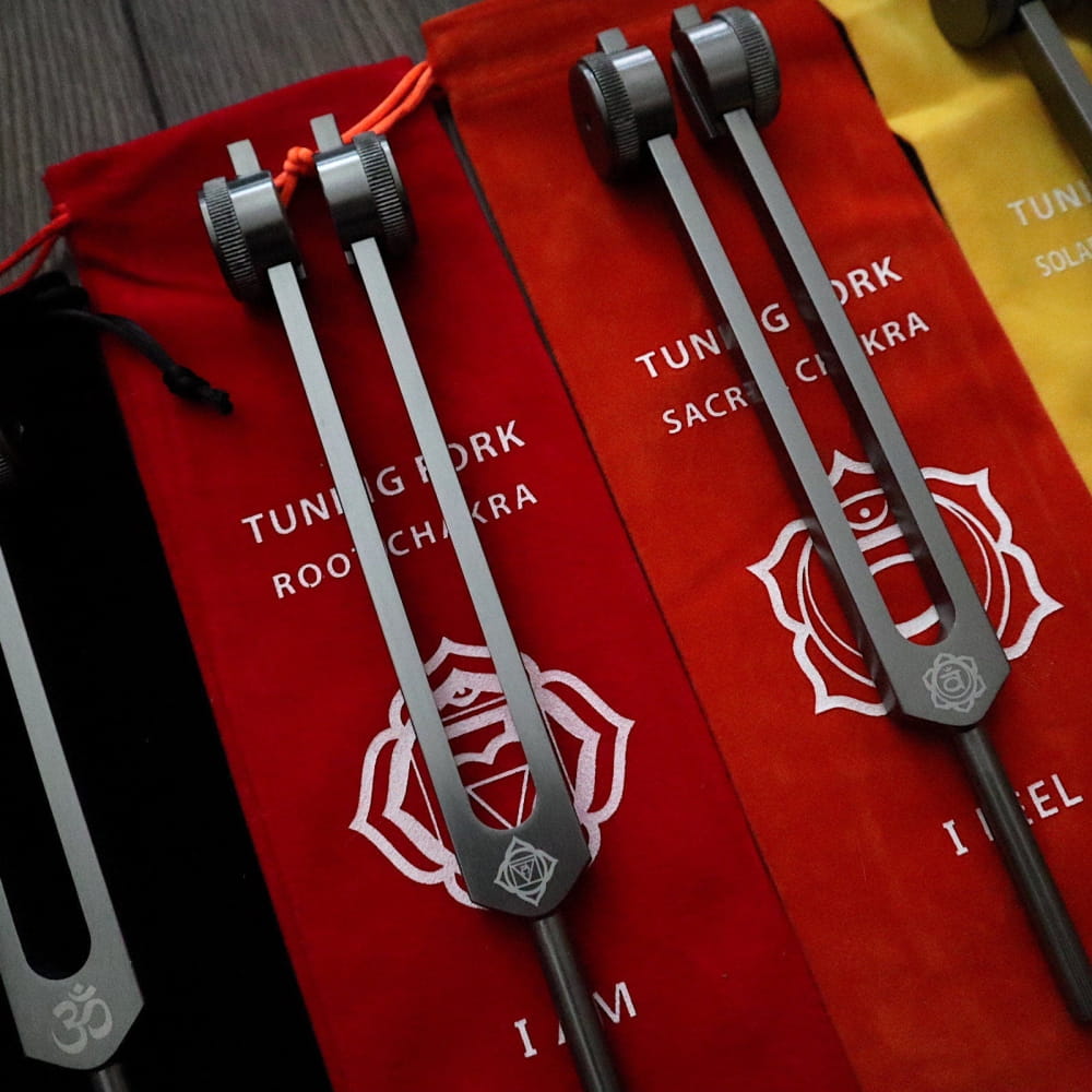 Tuning forks with lotus flower designs in red sleeves for Colorful Chakra Tote Bags