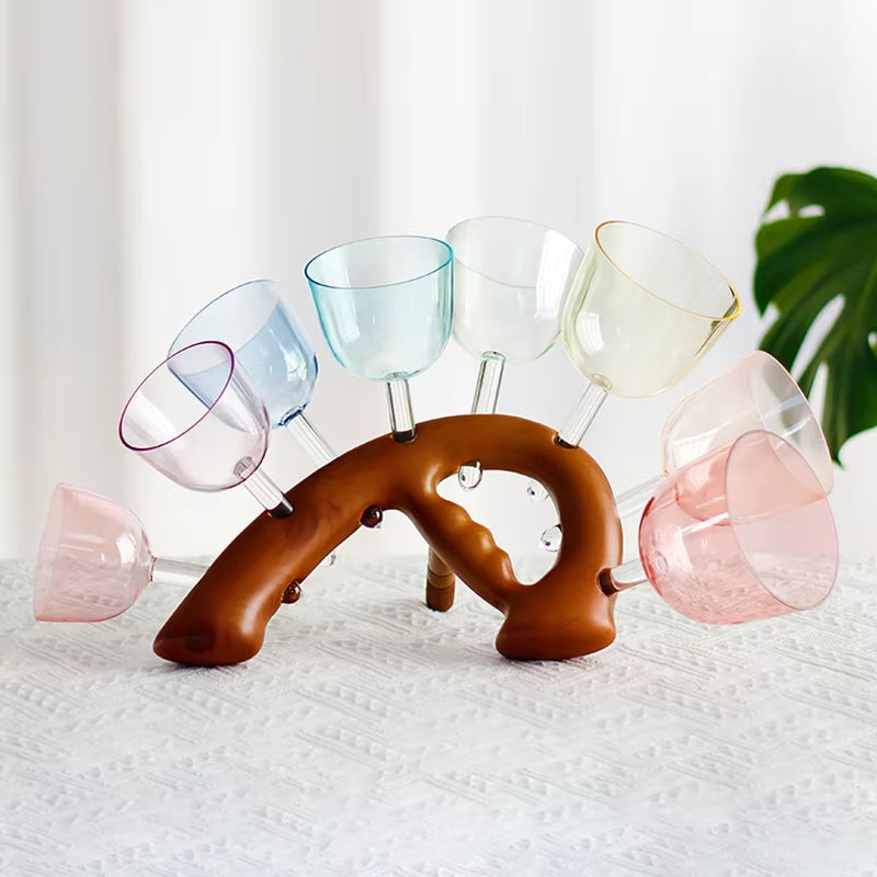 Curved wooden wine glass holder showcasing colorful crystal glasses in an arch