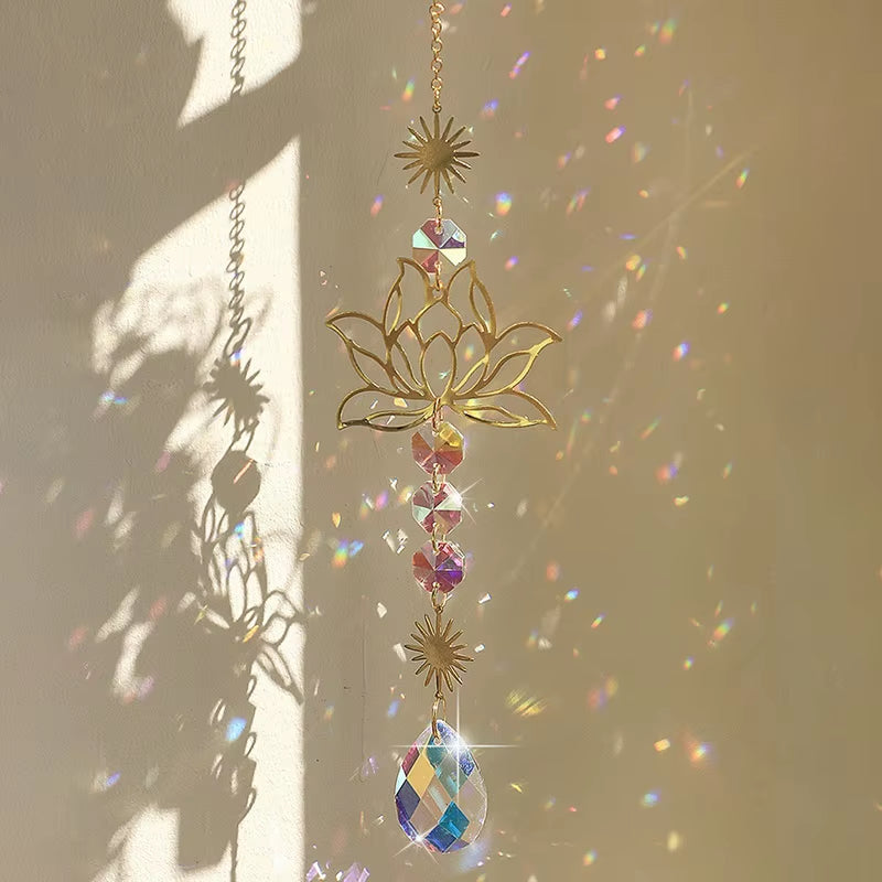 Hanging crystal suncatcher with lotus and star designs casting rainbow reflections