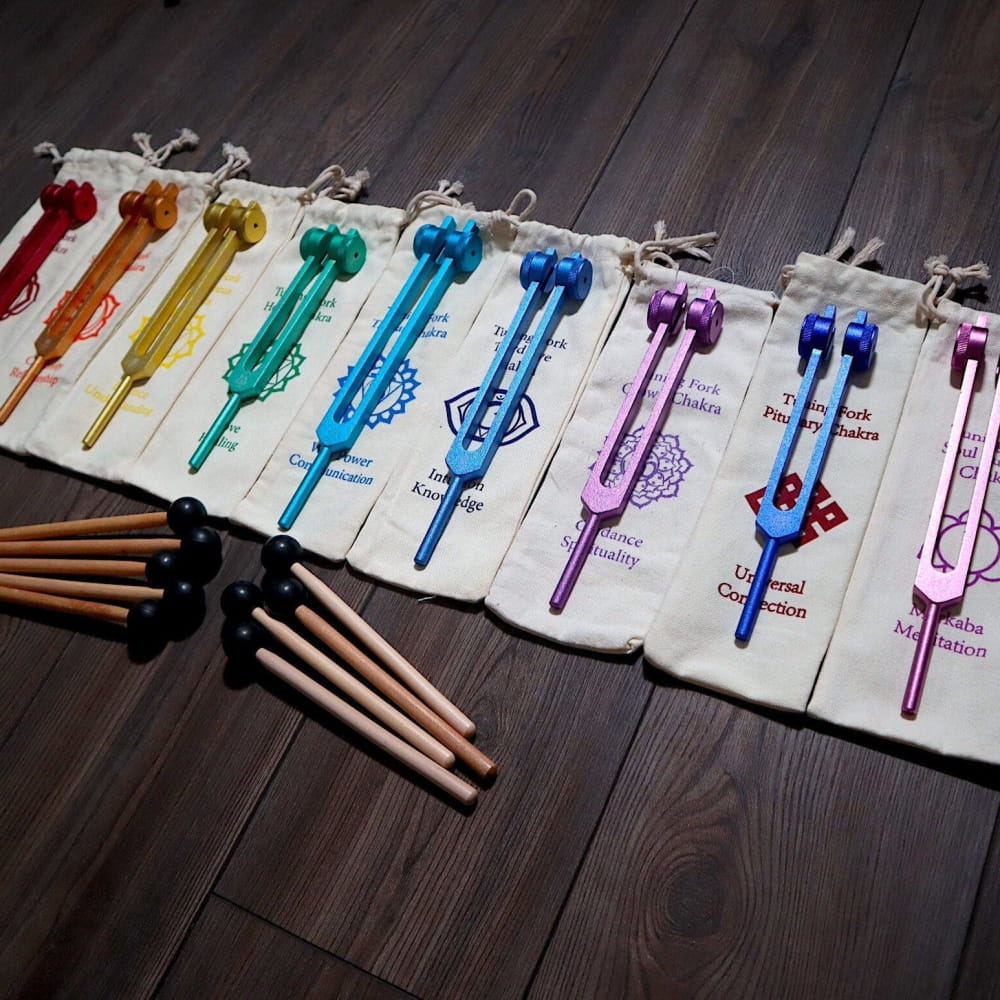 Colorful drumsticks in rainbow pattern on white cloth for Solfeggio Tuning Fork Set