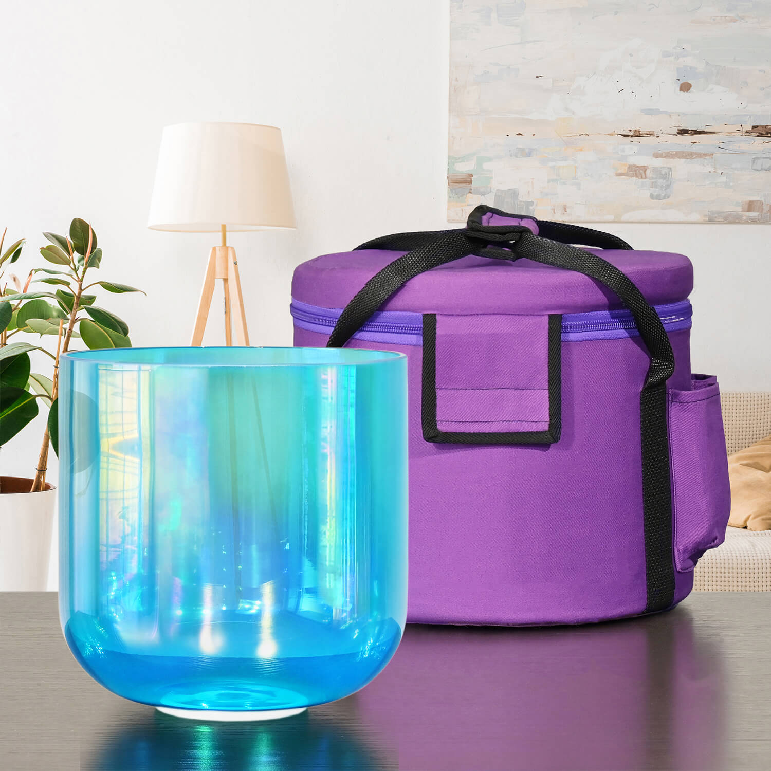 Iridescent Blue Crystal Singing Bowl next to a purple carrying case for meditation