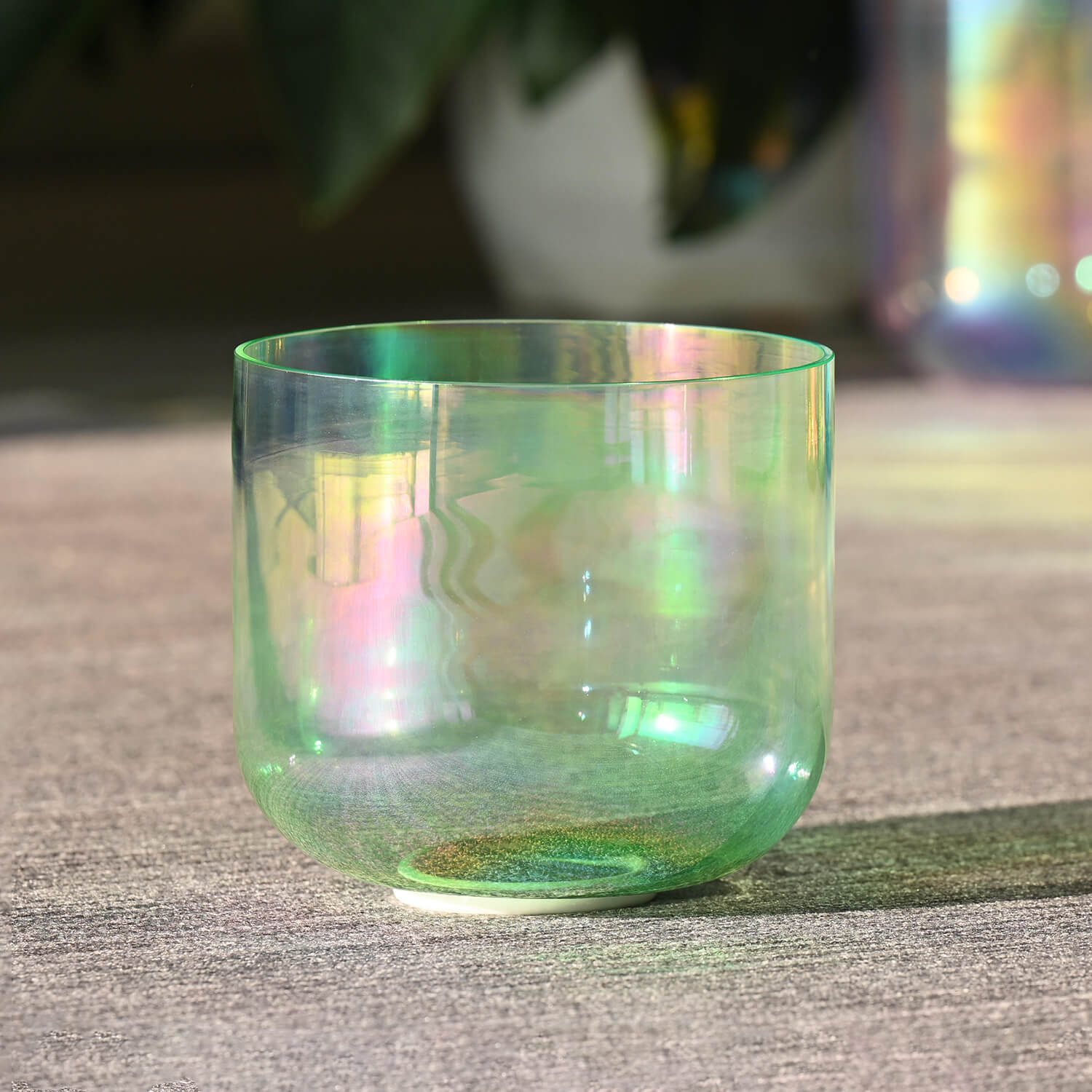 Iridescent glass bowl with rainbow sheen in Cosmic Light Clear Green Crystal Singing Bowl Set