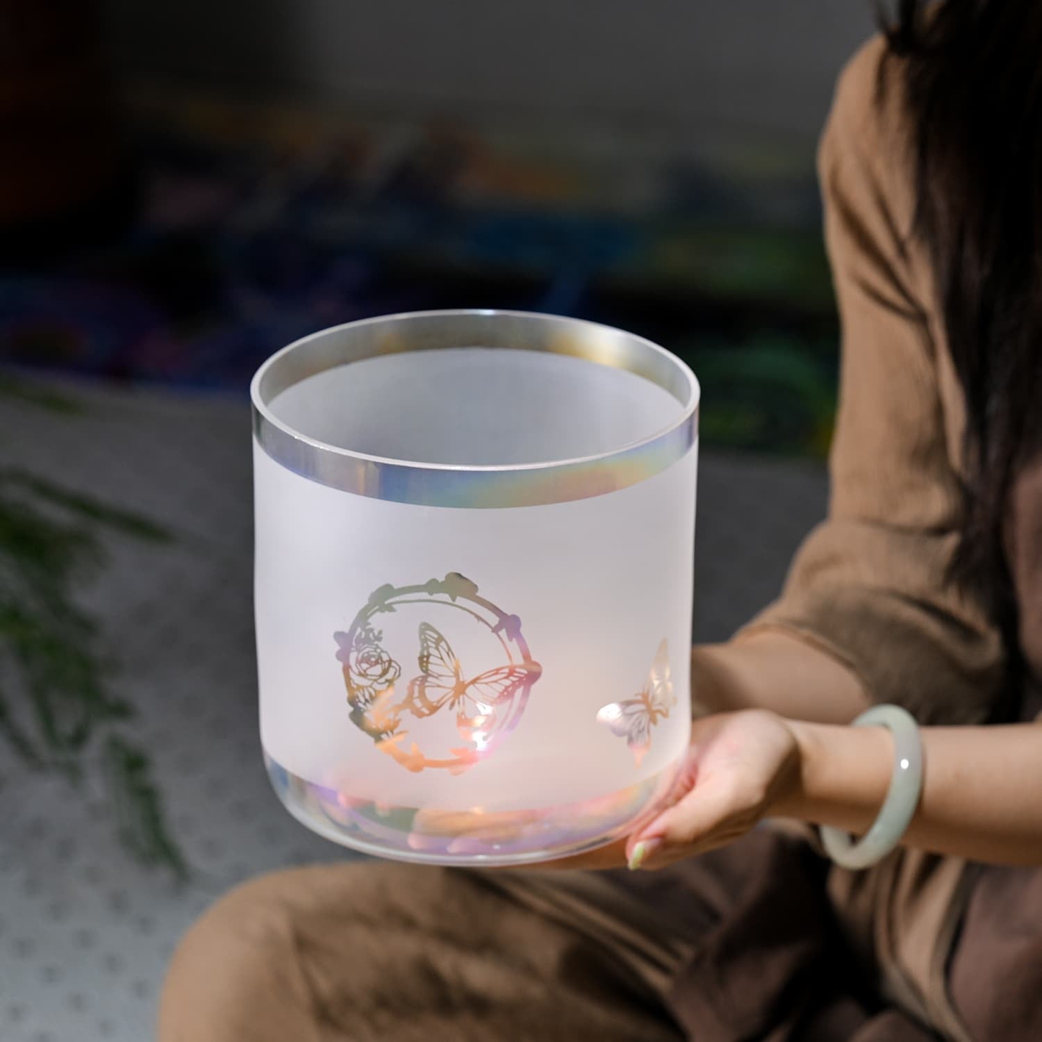 Frosted glass container with etched design glowing in Crystal Singing Bowl Butterfly Alchemy