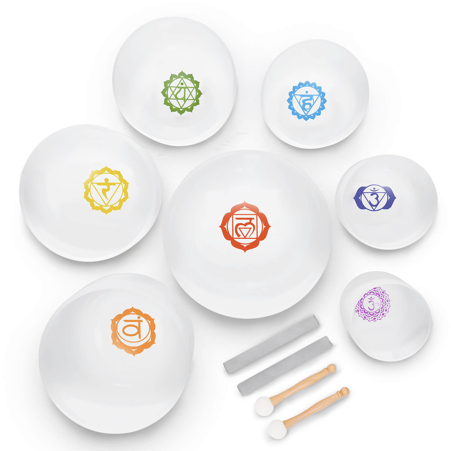 White plates with colorful chakra symbols and serving utensils for Crystal Singing Bowl Set