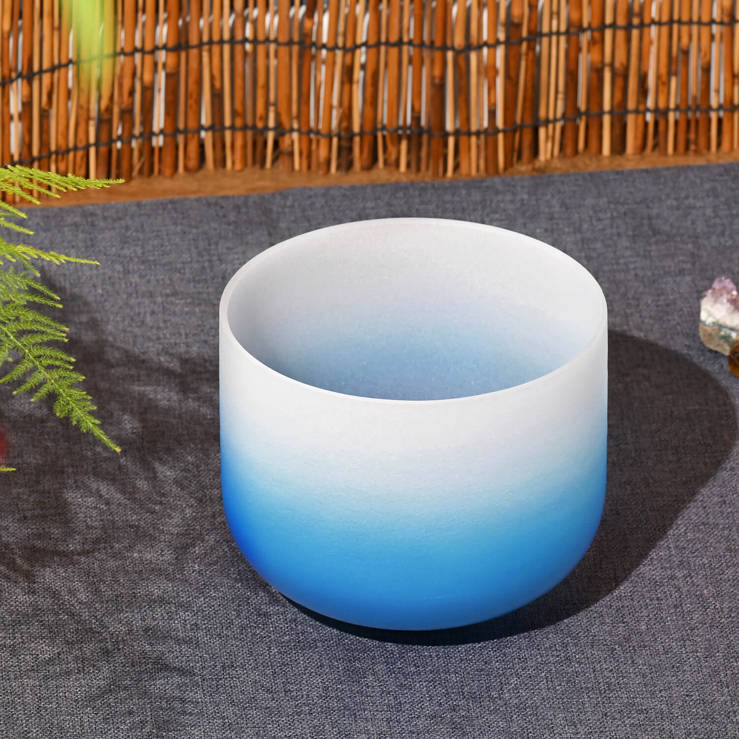 Frosted crystal singing bowl with blue gradient for Throat Chakra healing and meditation