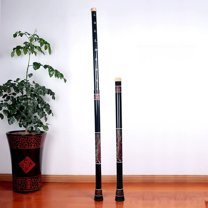 Two black bamboo flutes with red decorative patterns for Didgeridoo sound healing