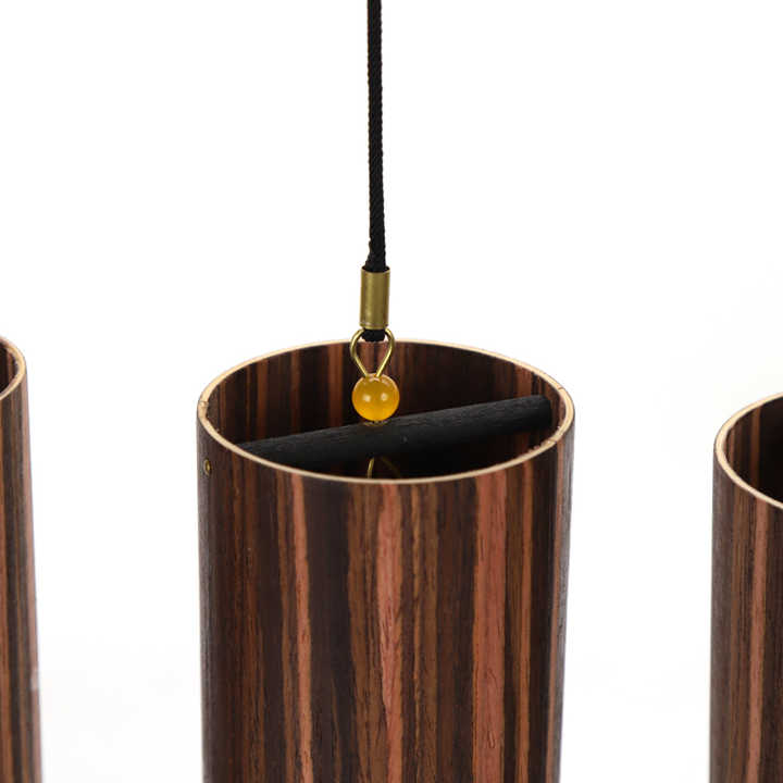 Cylindrical pendant light fixture with striped wood-like pattern for Elemental Wind Chimes Set