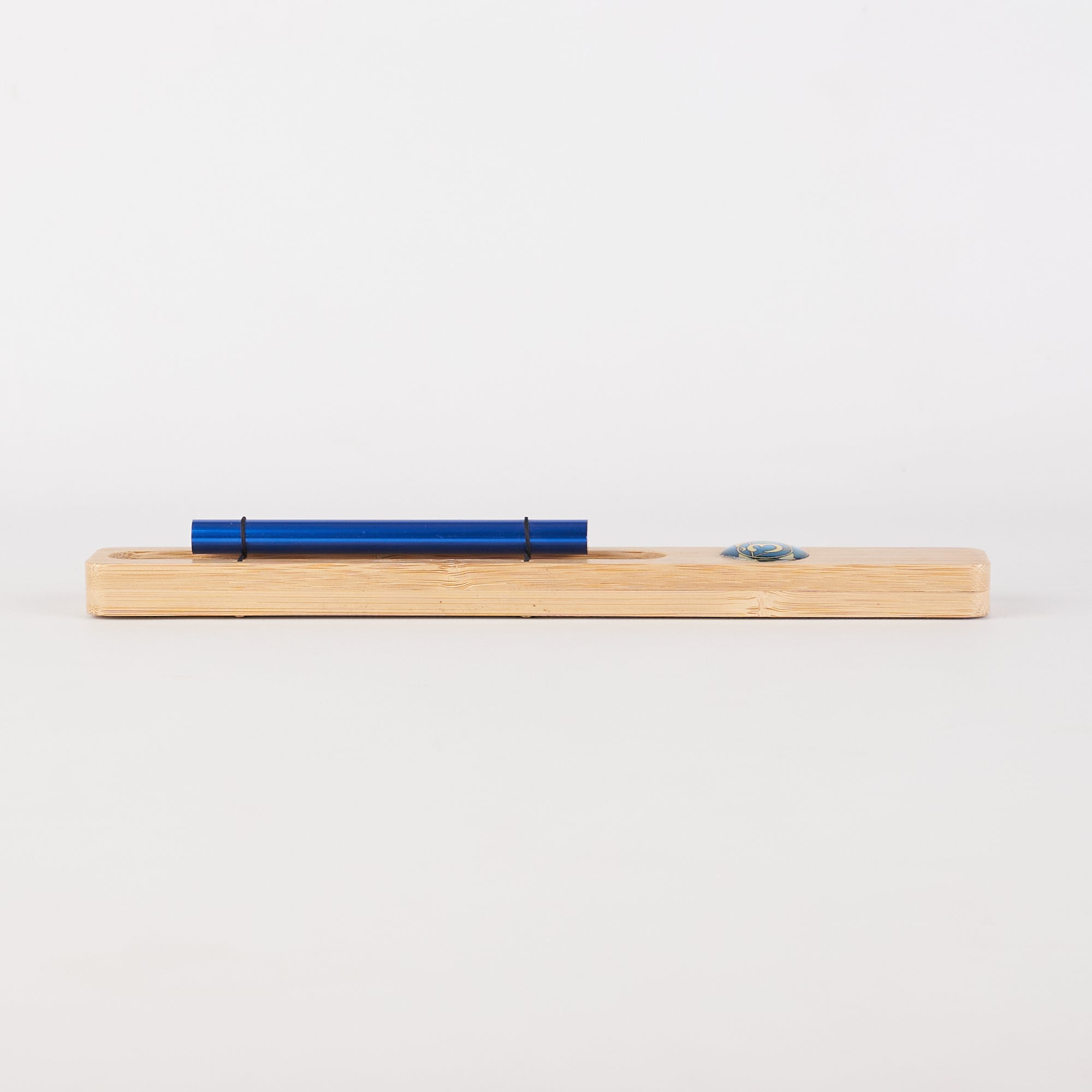 Blue pen on wooden surface beside Energy Bar Chimes for Chakra Meditation product