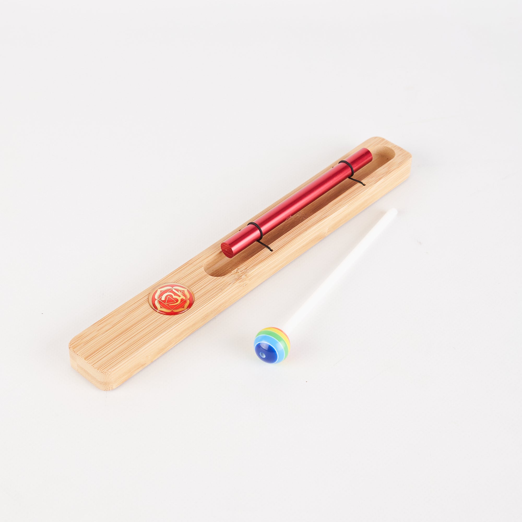 Red metal pen in wooden holder with blue marble for Energy Bar Chimes meditation