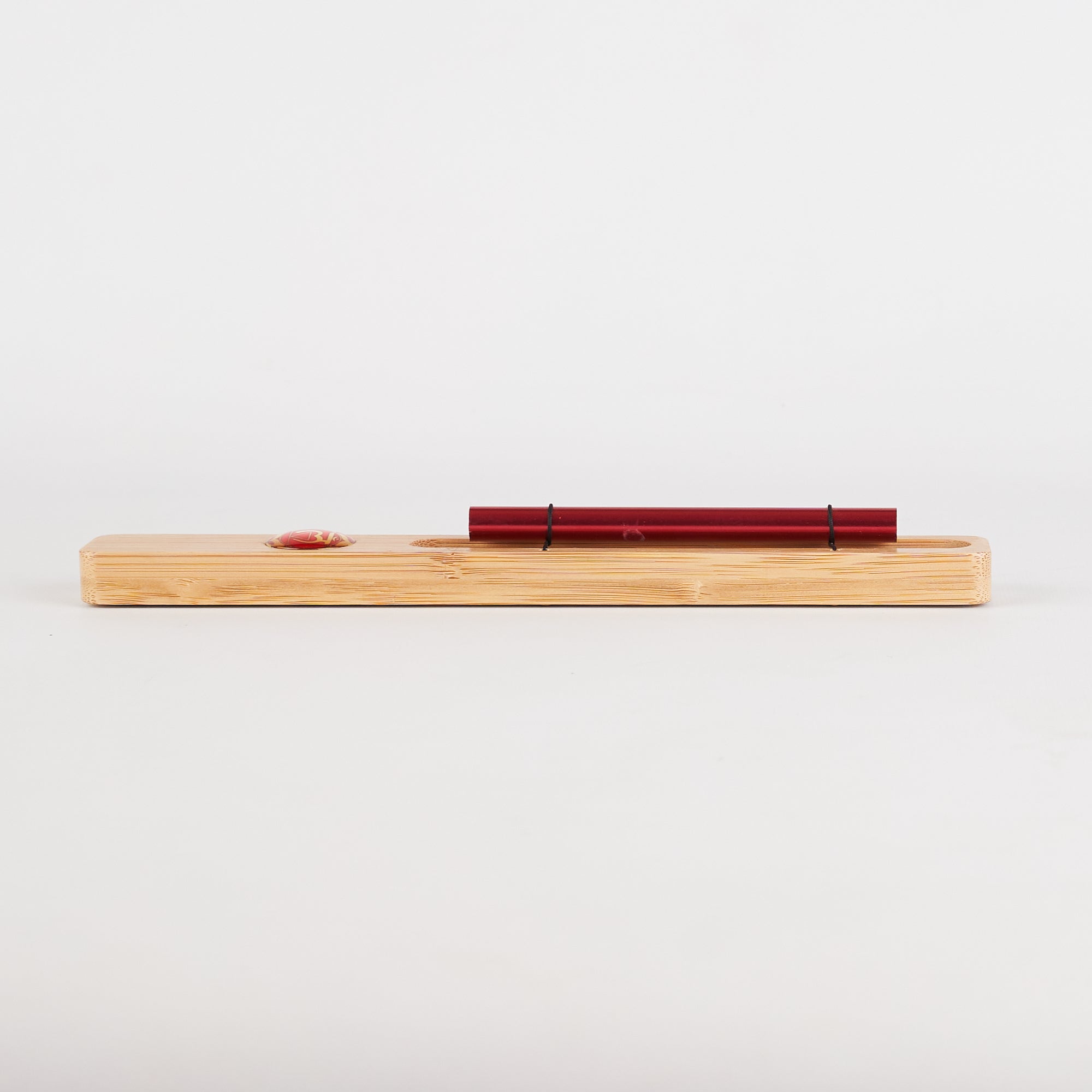 Wooden block with a red metal tube for Energy Bar Chimes in Chakra Meditation