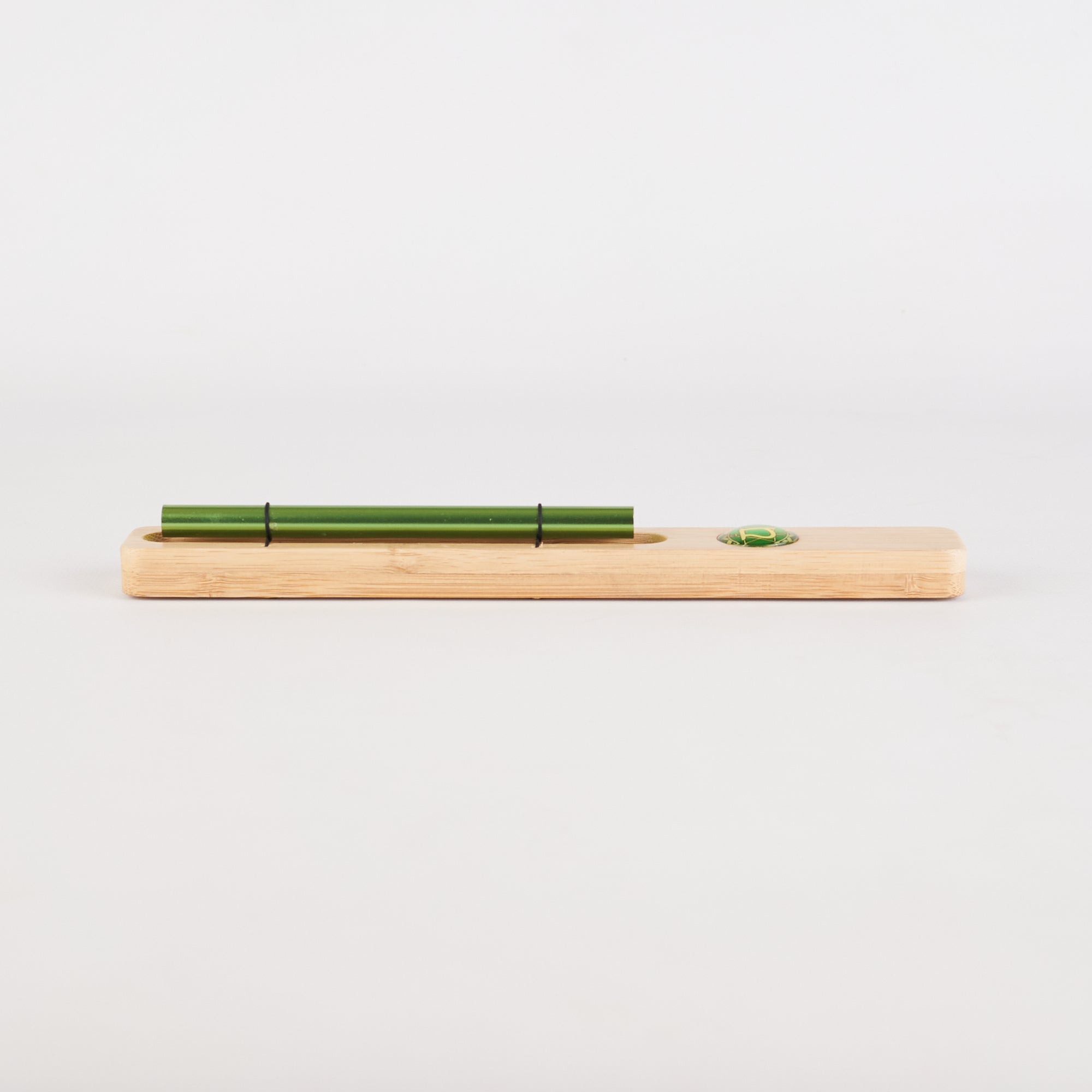 Wooden board with green pen and circular indent for Energy Bar Chimes Chakra Meditation