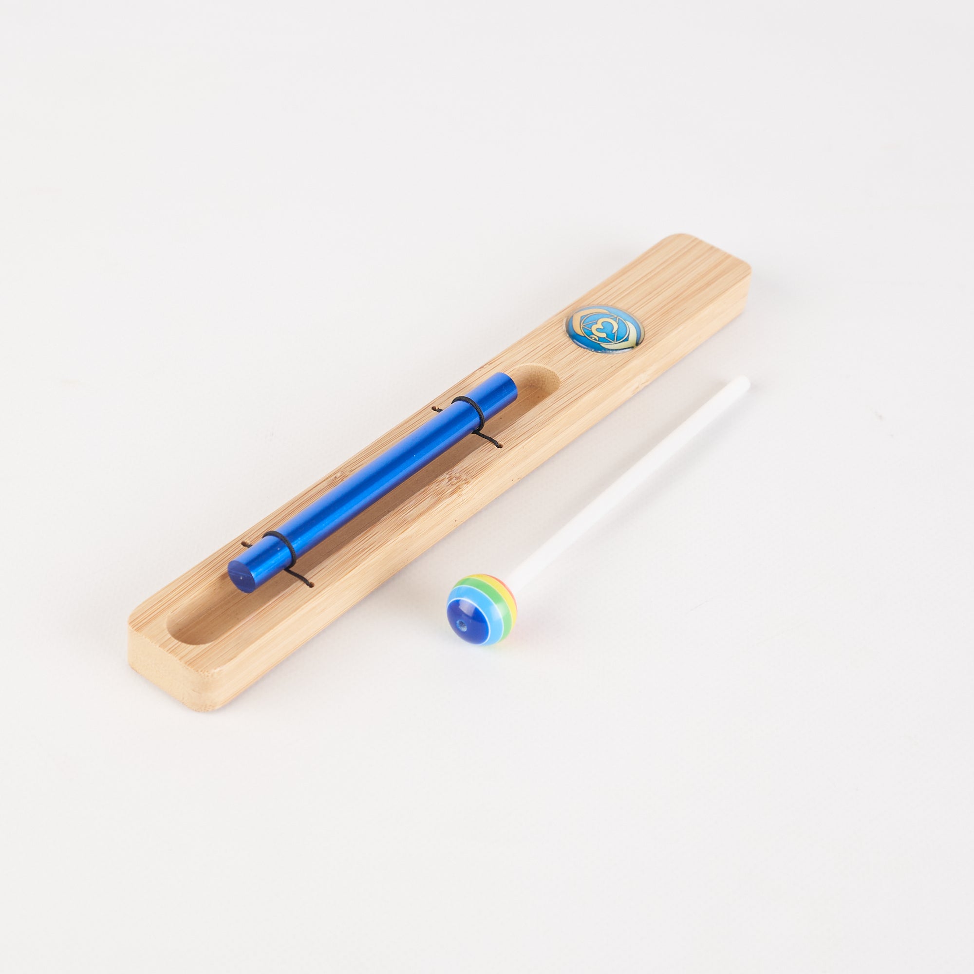 Wooden pencil case with blue pen and decorative marbles for Energy Bar Chimes product