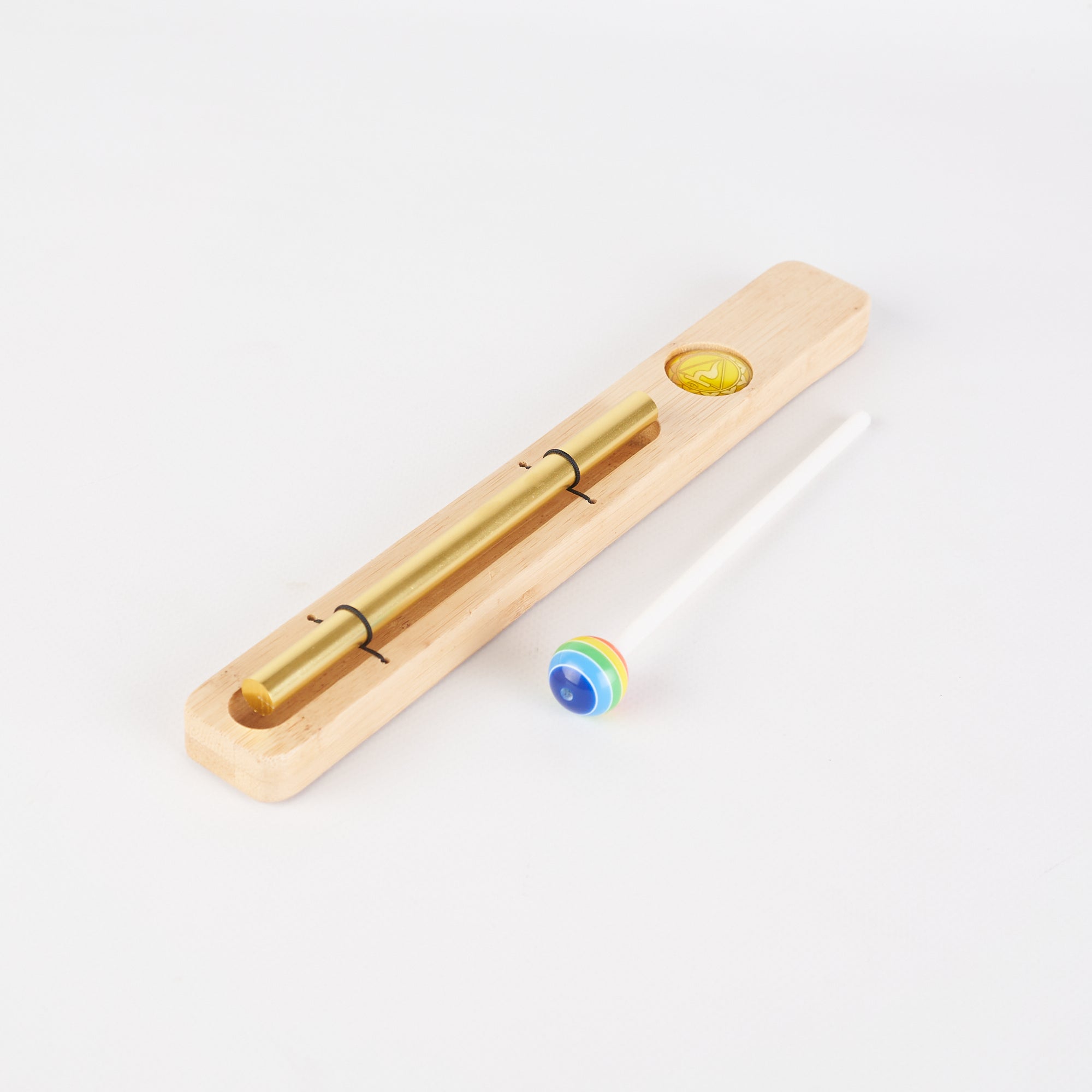 Wooden slide whistle and colorful marble in Energy Bar Chimes for Chakra Meditation