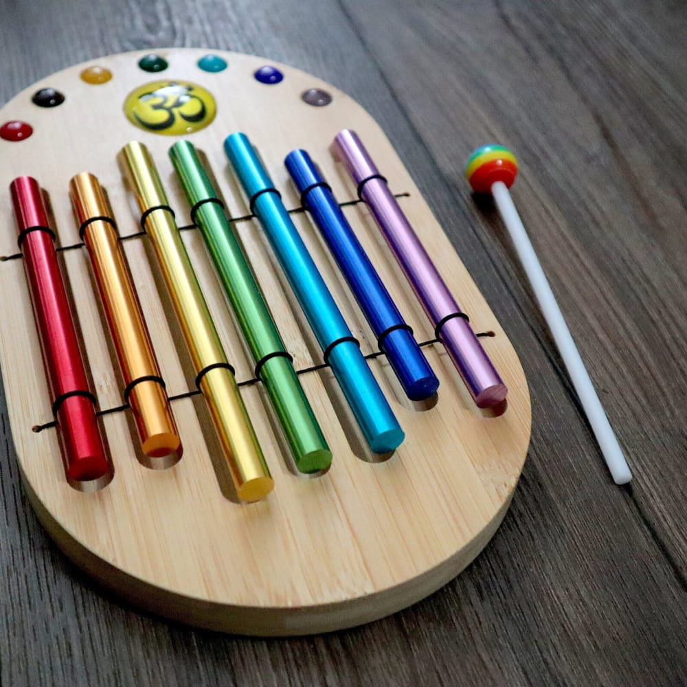 Rainbow-colored metallic chimes on oval wooden base for chakra healing Energy Bar Chimes Set