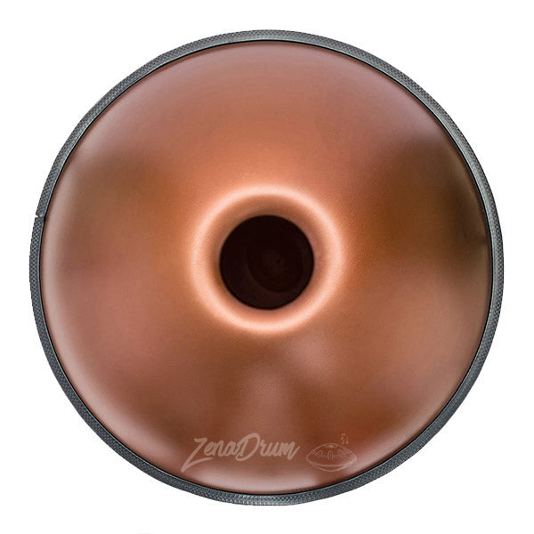 Chocolate-glazed donut with a hole in the center and F Major Handpan Drum nearby