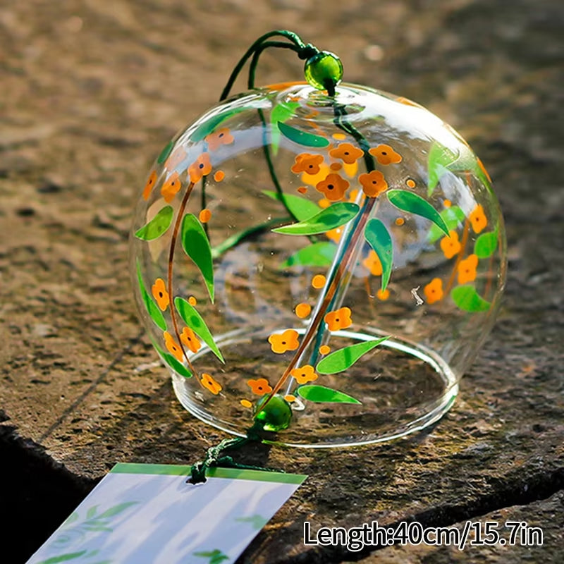 Glass wind chime bell with orange flowers and green leaves for outdoor decor