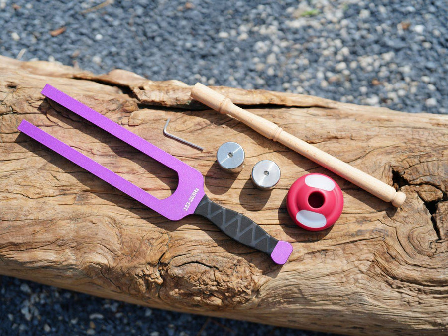 Purple tuning fork with washers and red bobber on wood for Giant Tuning Forks product