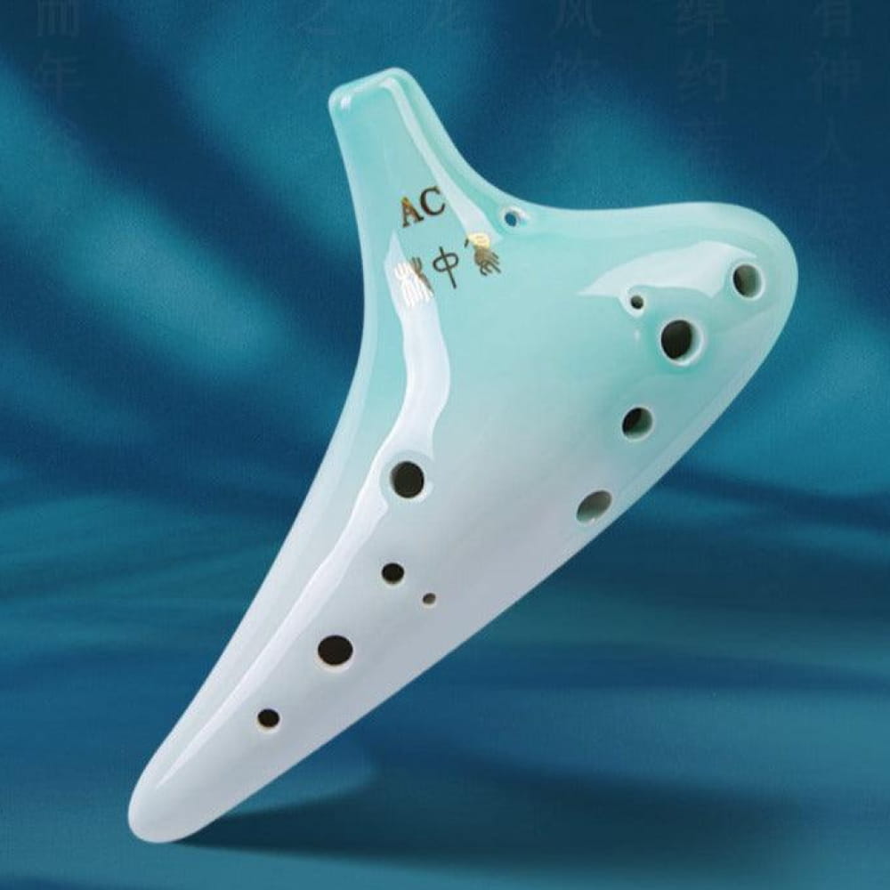 Mint green and white ceramic ocarina with 12 finger holes for musical performance