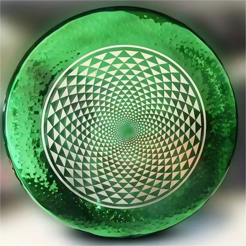 Green glass plate with geometric spiral triangles in Green Geometry Gong Instrument