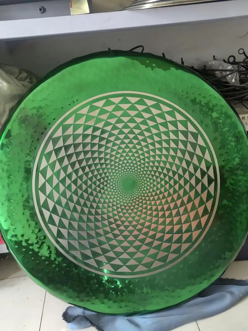 Green Geometry Gong Instrument featuring a spiral pattern on a metallic plate