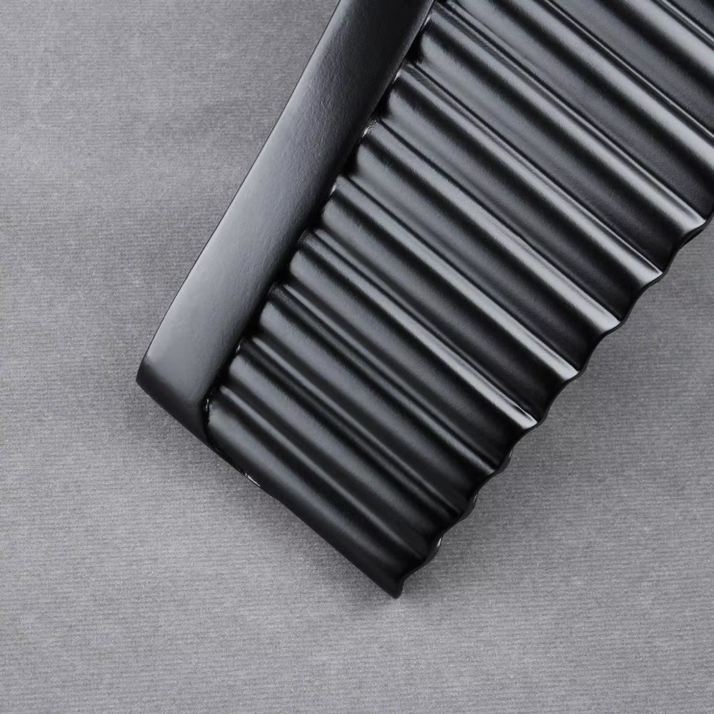 Black plastic comb with ridged teeth next to Handmade Bamboo Pan Flute G/C Key