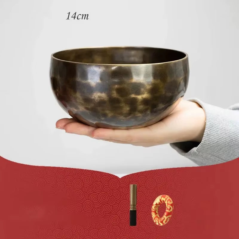 Hand-hammered Tibetan singing bowl with dark metallic finish for meditation