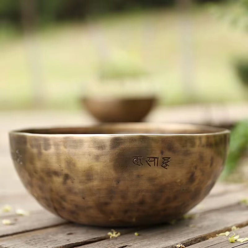 Antique Tibetan singing bowl with etched script, perfect for meditation practices