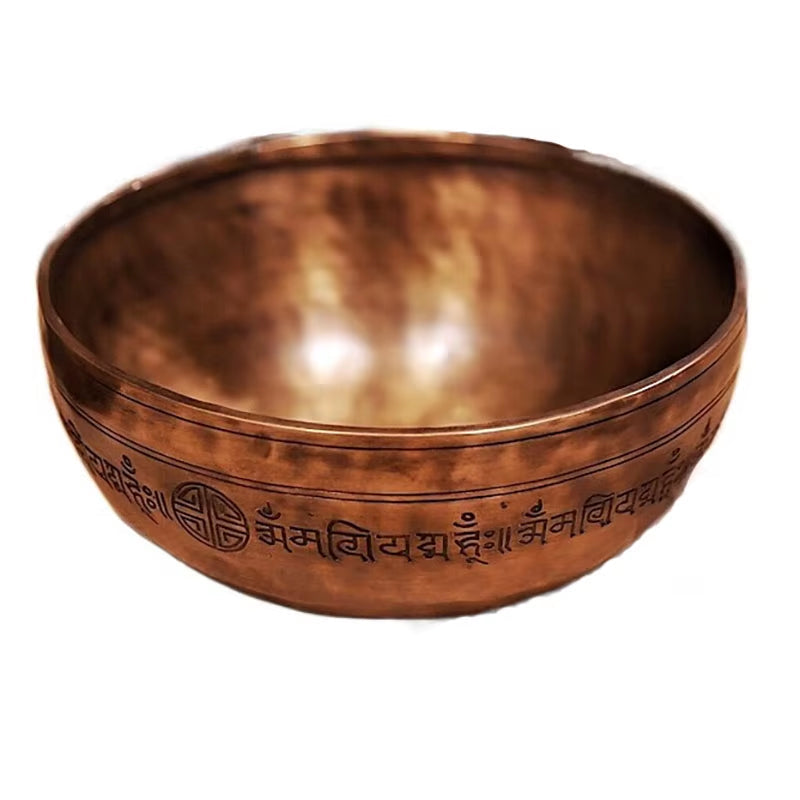 Copper Tibetan singing bowl with etched Sanskrit mantras for meditation and relaxation