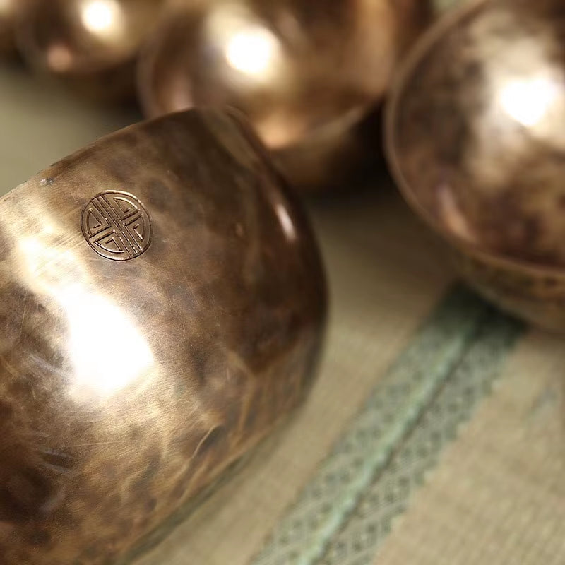 Hammered copper sphere with engraved symbol in Handmade Nepal Tibetan Singing Bowl