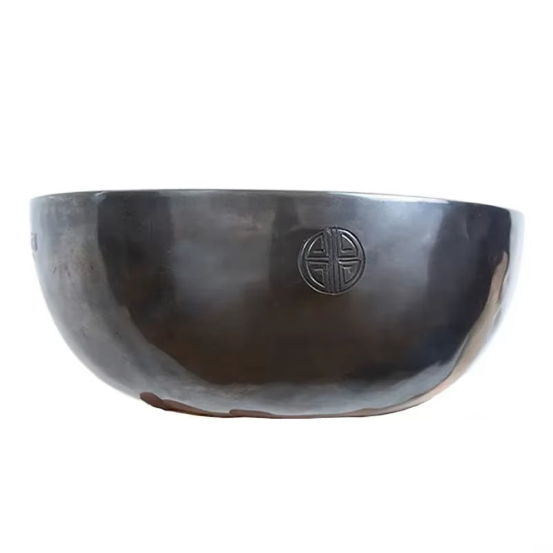 Dark ceramic Handmade Tibetan Singing Bowl with engraved Asian symbol for meditation