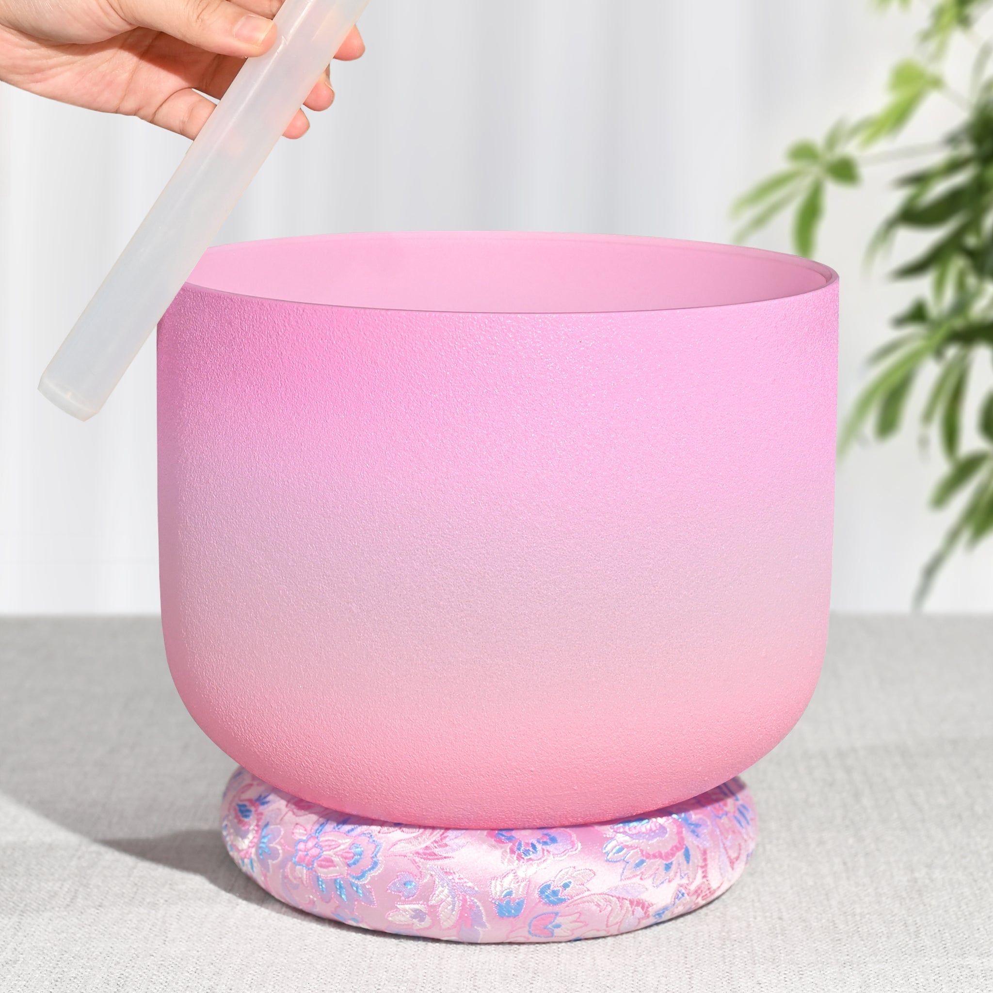 Pink Heart Chakra Quartz Crystal Singing Bowl on a decorative floral cushion base