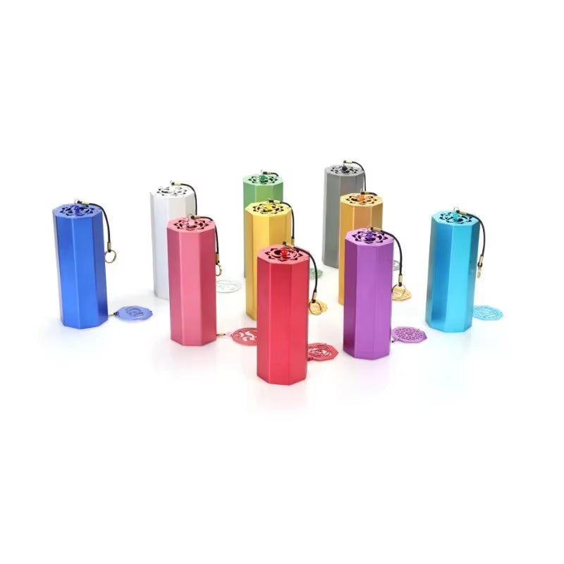 Colorful metallic pill containers with keychain attachments for Hexagonal Metal Koshi Chime Bells