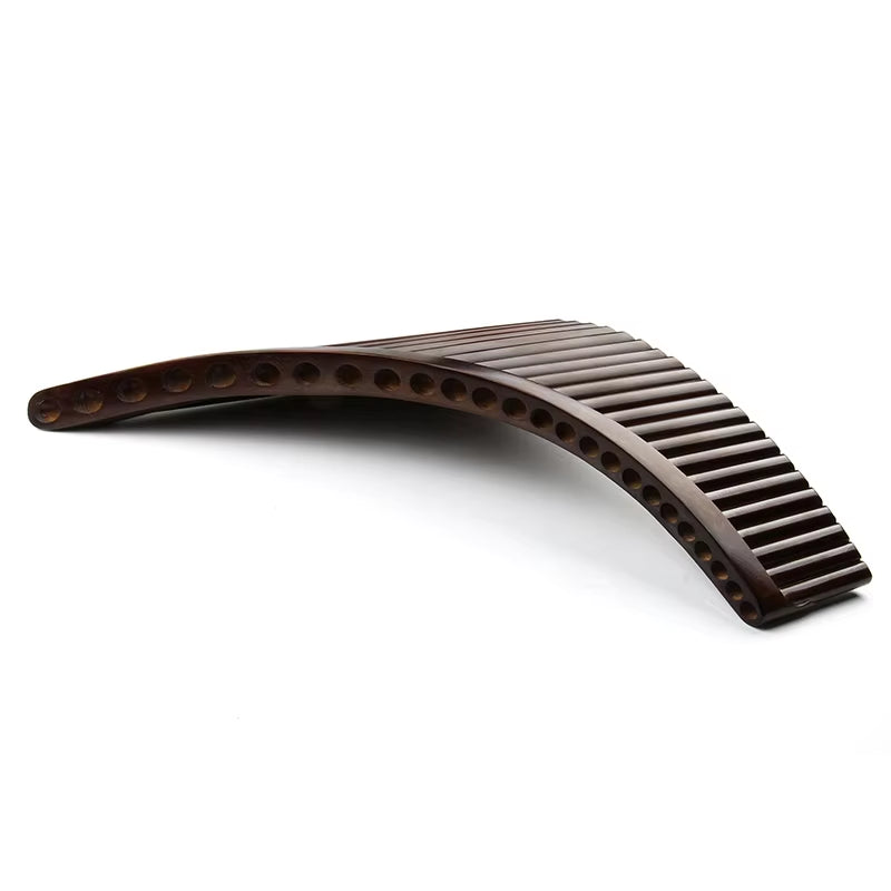 Curved brown plastic hair comb with wide-spaced teeth next to High-Quality Bamboo Pan Flute