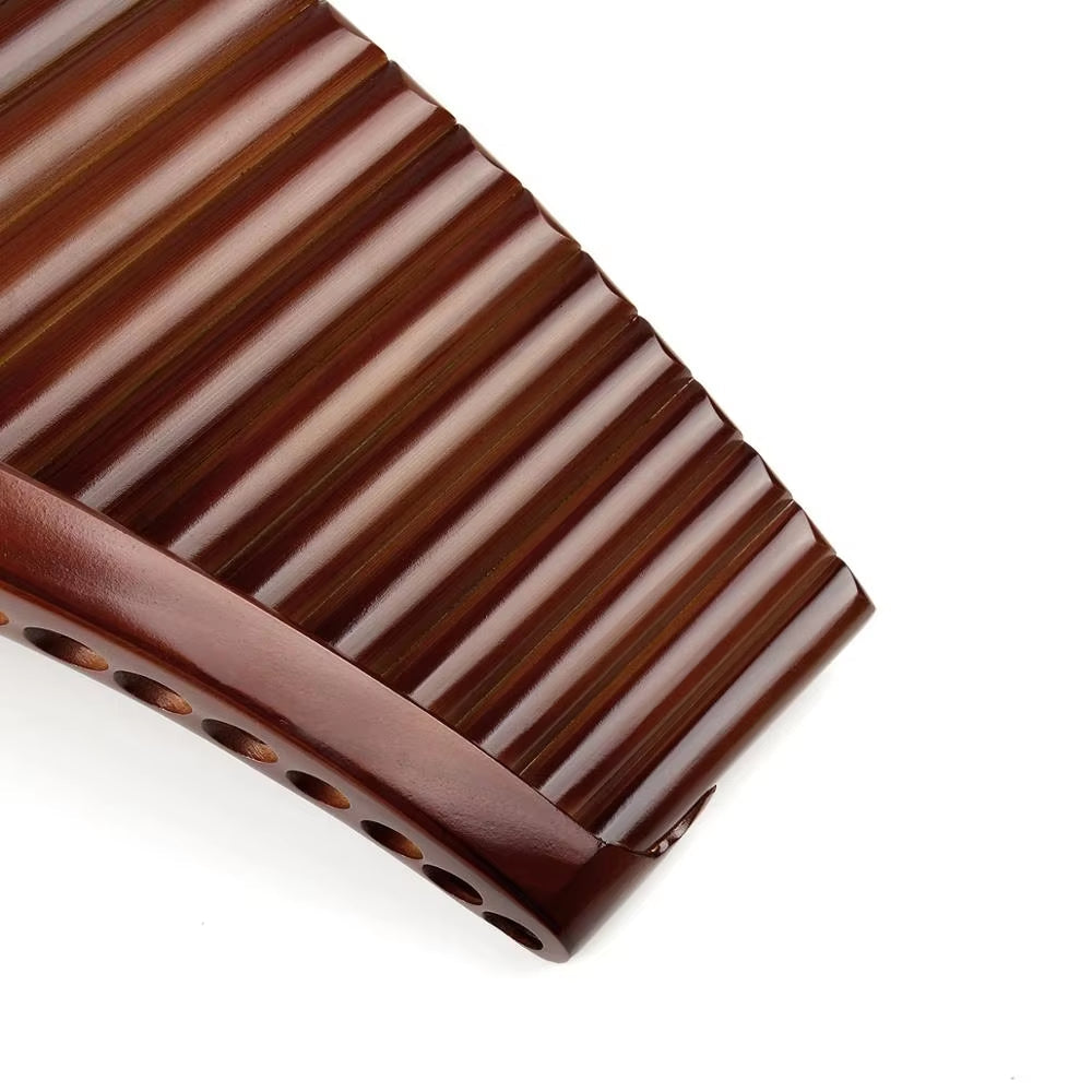 Dark chocolate bar with ridged texture beside High Quality Bamboo Pan Flute E Key