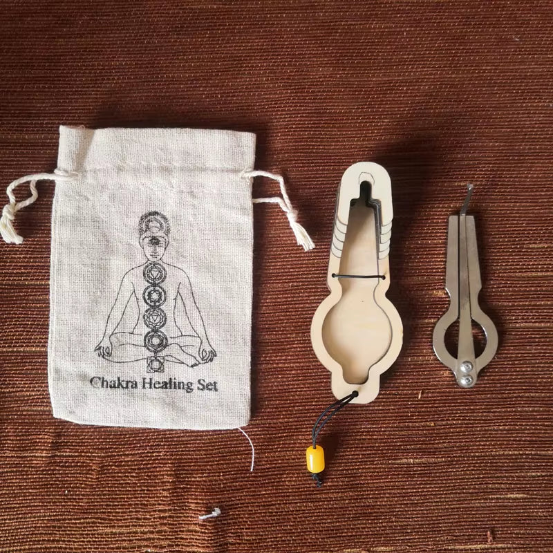 Chakra healing set with cloth bag and metal tools beside Jew Harp Musical Instrument E Major