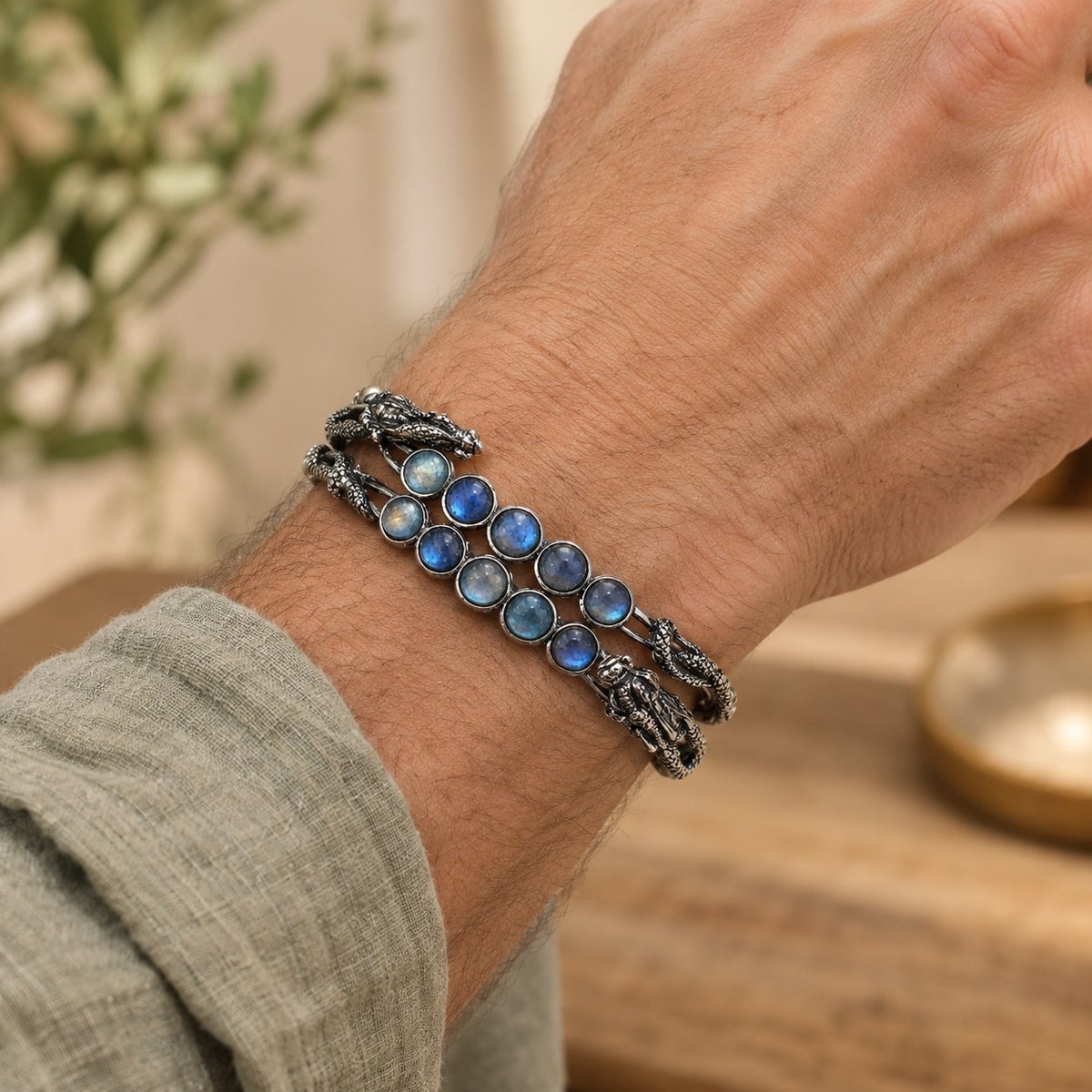 Adjustable Labradorite Crystal Healing Bangle with Dragon Motif, worn on the wrist by a man